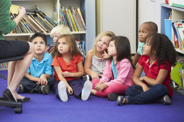Group of Elementary Pupils In Classroom Working With Teacher