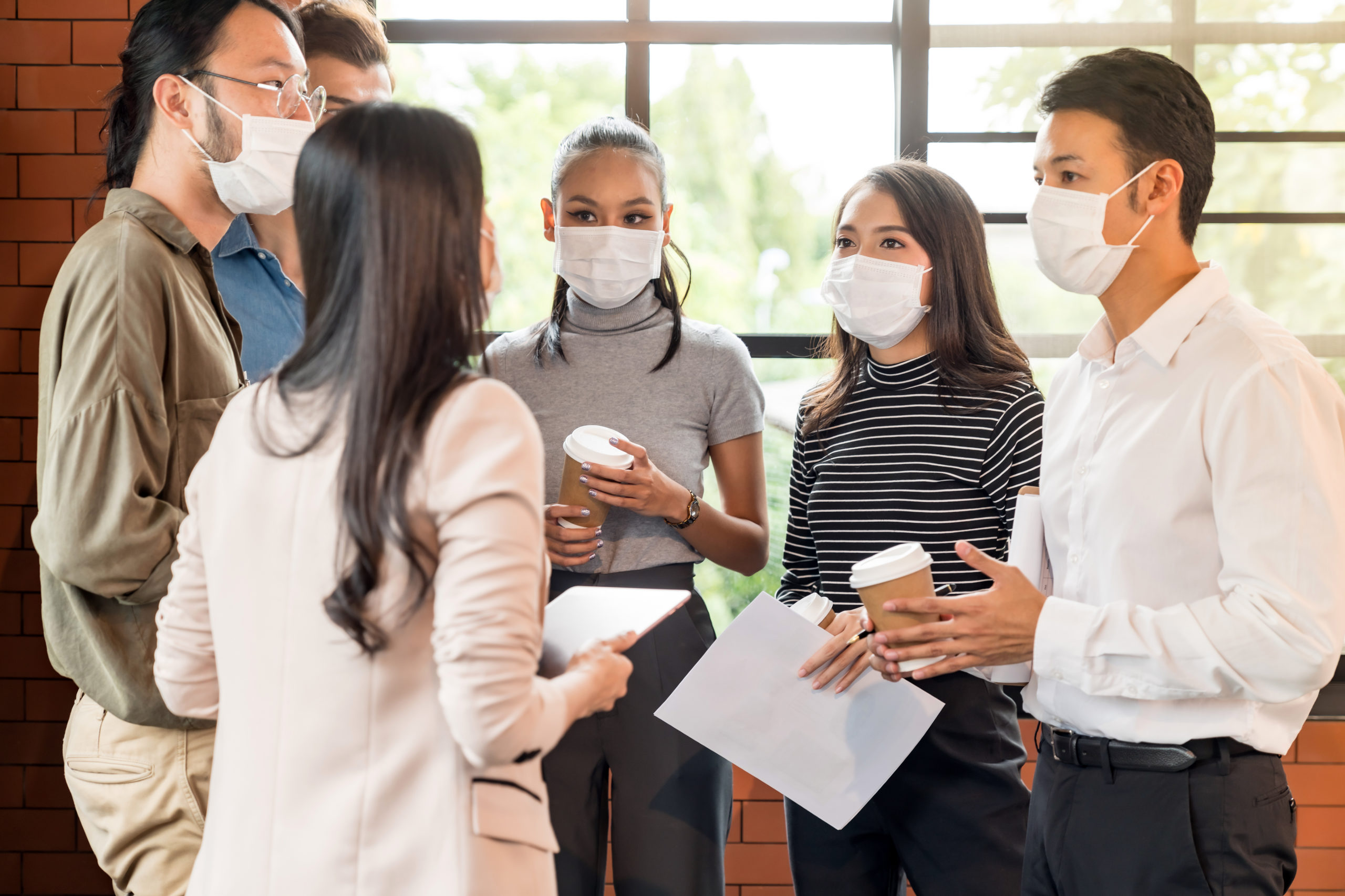 Businee person discussion meeting with face mask.