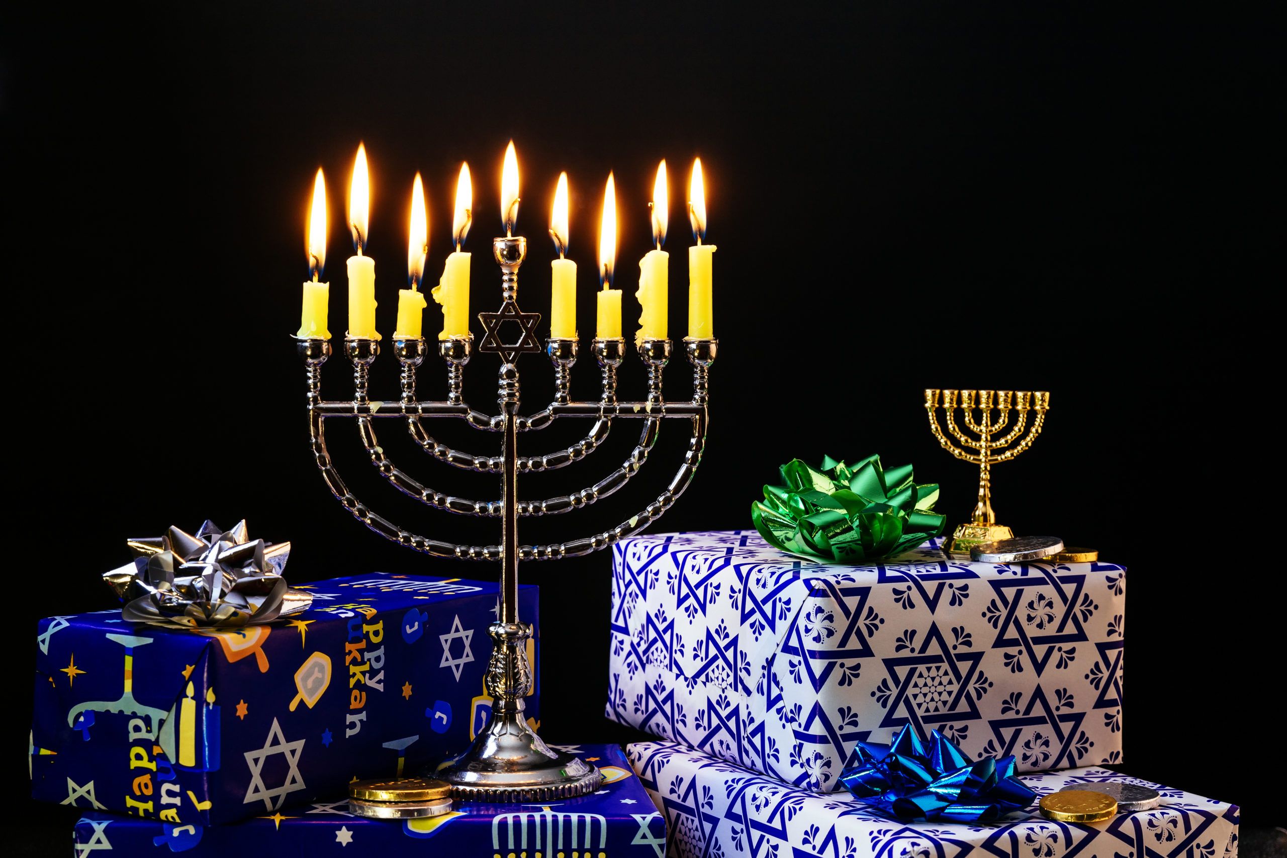 Nine burning candles on blurred background. Hanukkah concept